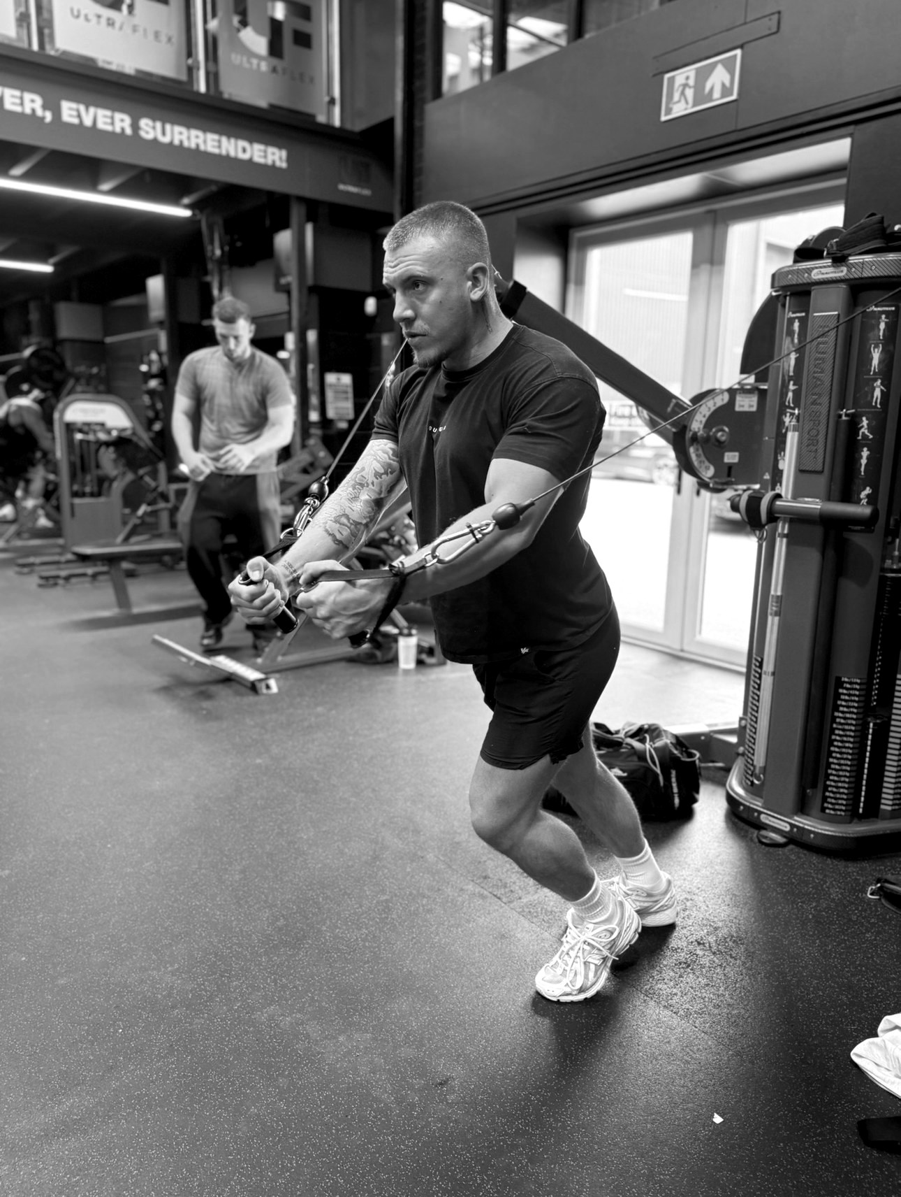 Cameron training on the cable machine